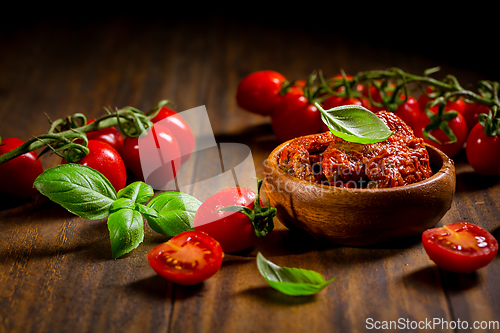 Image of Sun dried and pickled tomatoes with fresh herbs and spices