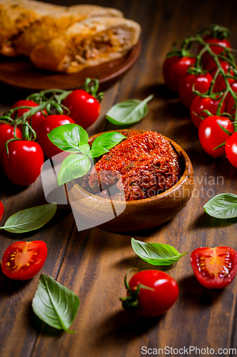 Image of Sun dried and pickled tomatoes with fresh herbs and spices