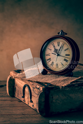 Image of Vintage alarm clock with copy space. Photo in retro color image style