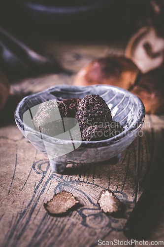 Image of Truffles and shiitake mushrooms and spices on kitchen table