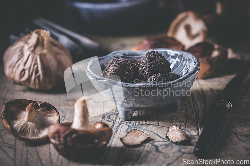 Image of Truffles and shiitake mushrooms and spices on kitchen table