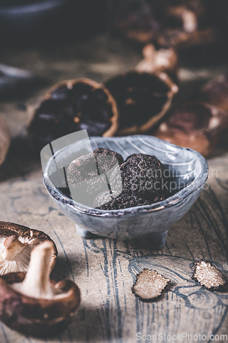 Image of Truffles and shiitake mushrooms and spices on kitchen table