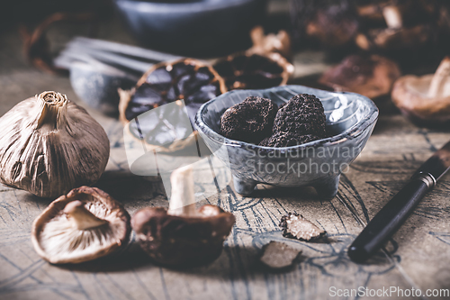 Image of Truffles and shiitake mushrooms and spices on kitchen table