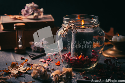 Image of Fall candle decoration with dried leaves, autumn wooden home decor still life scented candle, autumn season interior decoration details