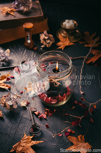 Image of Fall candle decoration with dried leaves, autumn wooden home dec