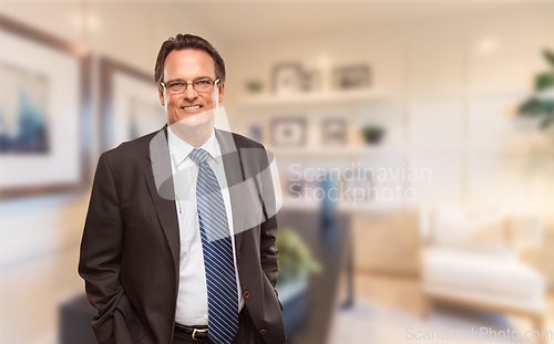 Image of Handsome Businessman In Suit and Tie Standing in His Office