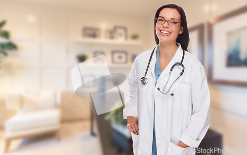 Image of Young Female Doctor or Nurse Standing in Her Office