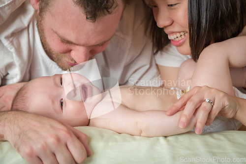 Image of Mixed Race Chinese and Caucasian Baby Boy Laying In Bed with His