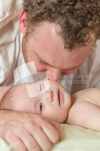 Image of Mixed Race Chinese and Caucasian Baby Boy Laying In Bed with His