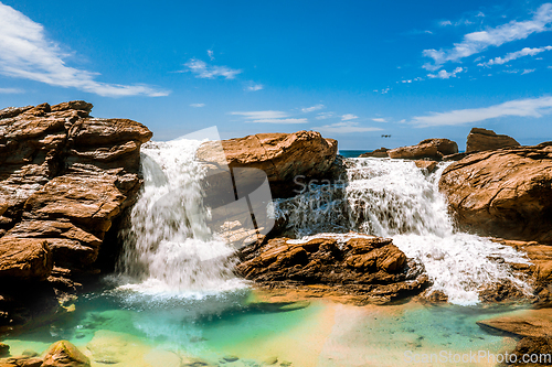 Image of Waterfall into ocean rock pool