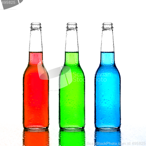 Image of bottles red green and blue with reflection isolated on white