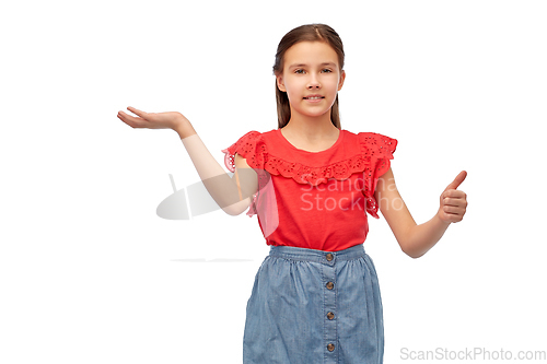 Image of happy girl showing thumbs up and holding something