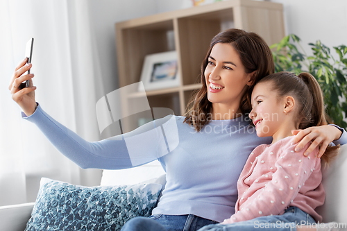 Image of happy family taking selfie by smartphone at home