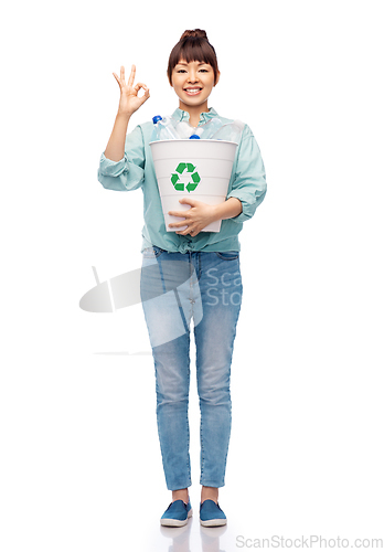 Image of smiling young woman sorting plastic waste