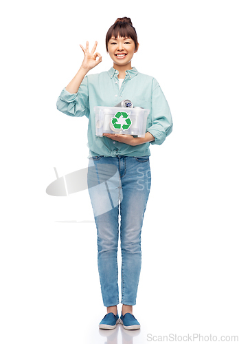 Image of smiling young asian woman sorting metallic waste