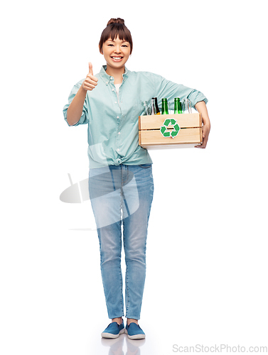 Image of smiling young asian woman sorting glass waste