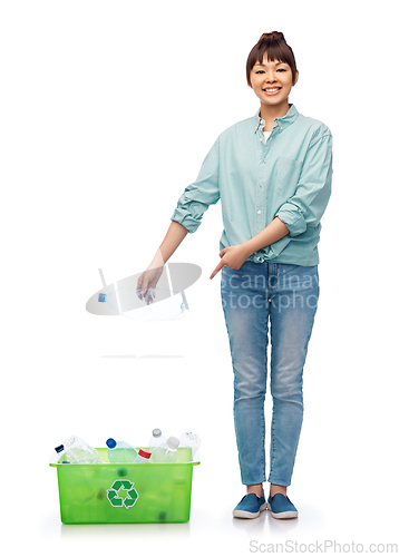 Image of smiling young asian woman sorting plastic waste