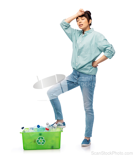 Image of tired young asian woman sorting plastic waste