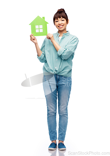 Image of smiling asian woman holding green house