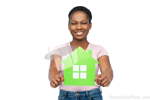 Image of smiling african american woman holding green house