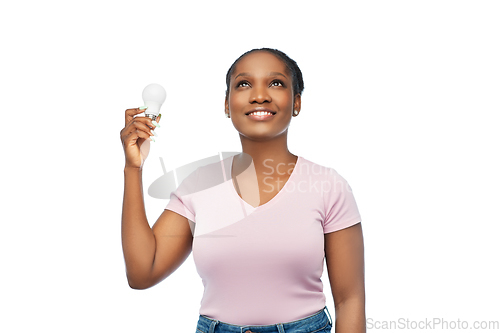 Image of african american woman holding lighting bulb