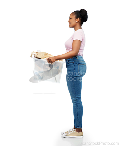 Image of happy african american woman sorting paper waste