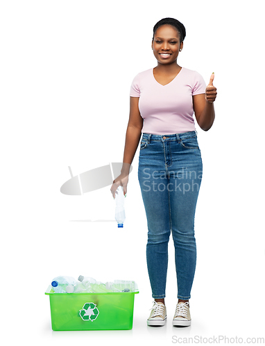 Image of smiling young asian woman sorting plastic waste