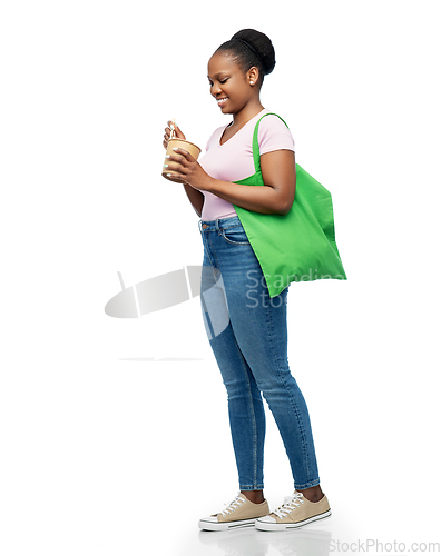 Image of happy woman with reusable bag for food and wok