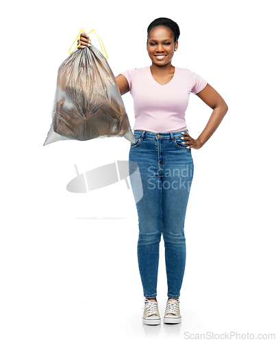 Image of smiling woman holding plastic trash bag with waste