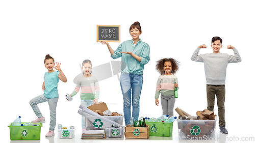 Image of happy woman with little children sorting waste