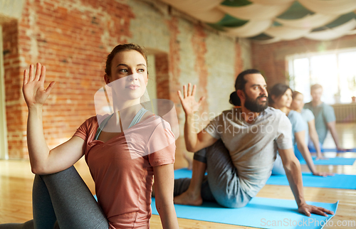 Image of group of people doing yoga at studio