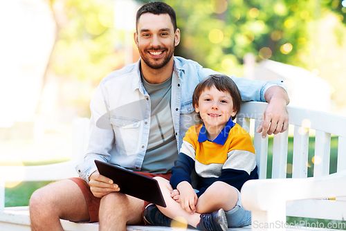 Image of father and son with tablet pc computer at park