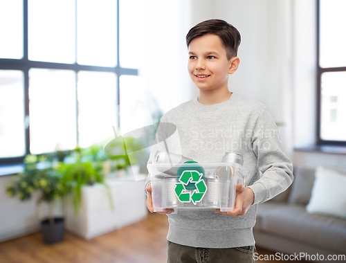 Image of smiling boy sorting metallic waste