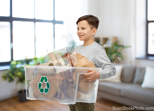 Image of smiling boy sorting paper waste