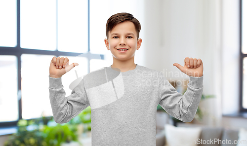 Image of happy smiling boy pointing fingers at himself