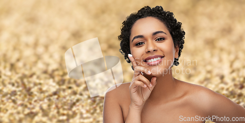 Image of young african american woman with moisturizer