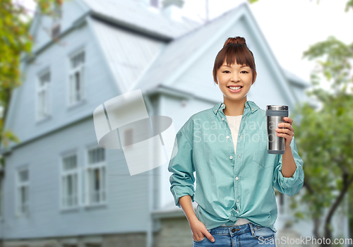 Image of woman with thermo cup or tumbler for hot drinks