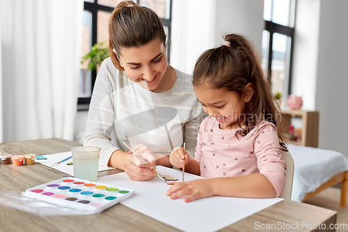 Image of mother with little daughter drawing at home