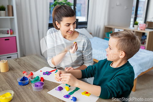 Image of mother and son playing with modeling clay at home