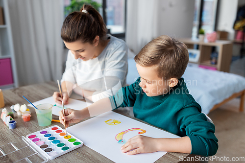 Image of mother and son with colors drawing at home