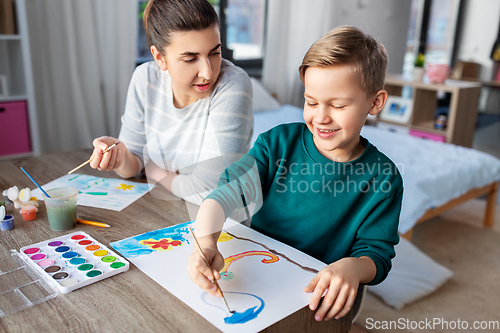 Image of mother and son with colors drawing at home