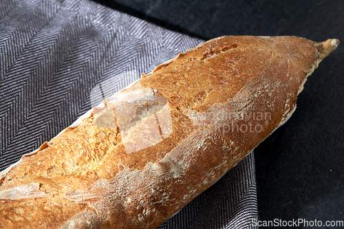 Image of close up of baguette bread on kitchen towel