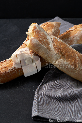 Image of close up of baguette bread on kitchen towel