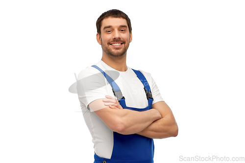 Image of happy smiling male worker or builder in overall