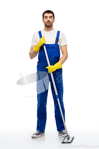 Image of male cleaner in overal cleaning floor with mop