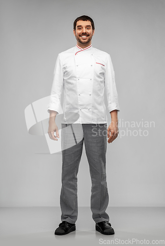 Image of happy smiling male chef in jacket