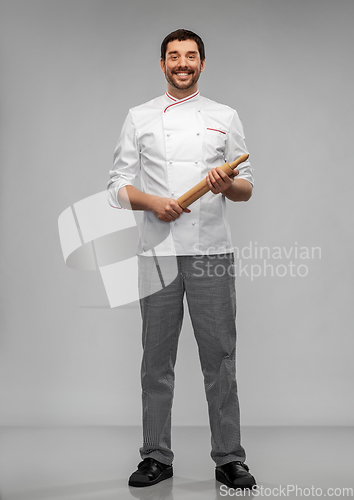 Image of happy smiling male chef or baker with rolling pin