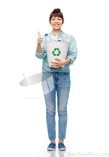 Image of smiling young woman sorting plastic waste