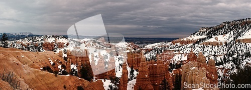 Image of Bryce canyon panorama in overcast winter day with orange rocks and snow