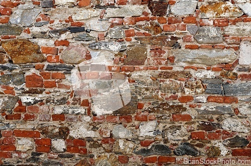 Image of Texture of old wall built of red bricks and uneven stones